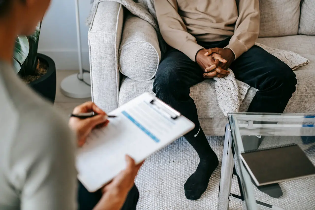 A doctor attentively speaking with a patient during a medical consultation, conveying professional care, diagnosis, and treatment guidance in a clinical setting.
