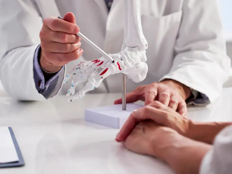 Medical professional performing a physical exam on a patient's foot to check for signs of peripheral neuropathy and nerve sensitivity.