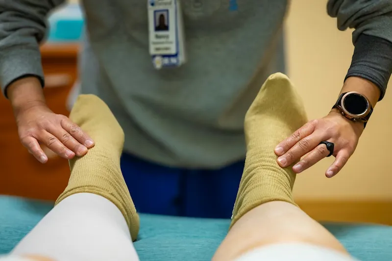 Close-up of a healthcare provider examining a patient's foot for nerve sensitivity and neuropathy symptoms.