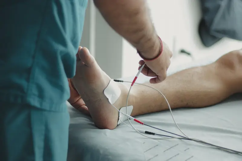 Healthcare professional performing a clinical sensory exam on a patient's foot to assess for neuropathy.