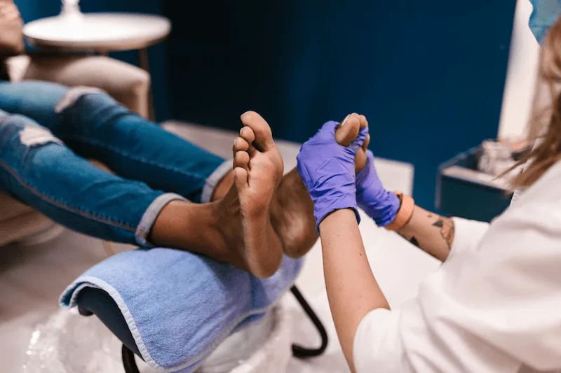 Healthcare professional performing a clinical foot examination to assess nerve sensitivity and neuropathy indicators.